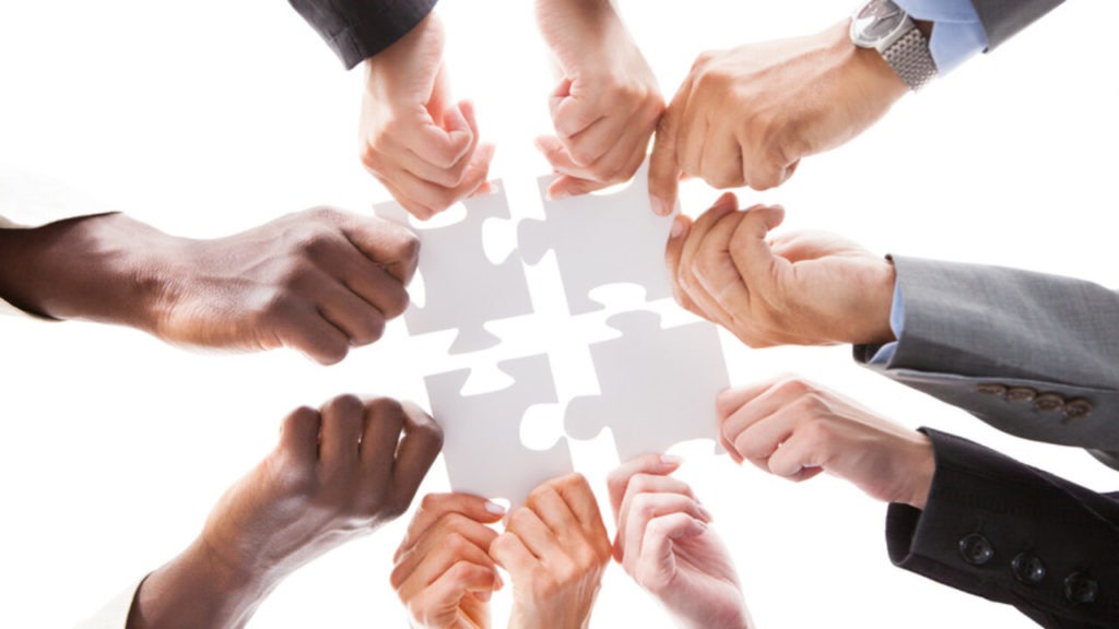 Businesspeople Holding Jigsaw Puzzle